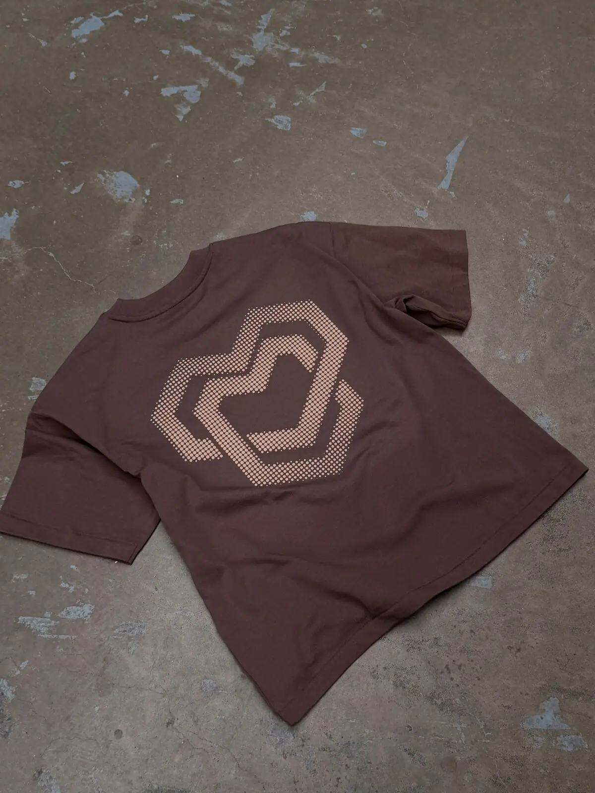 The finished shirt with the halftone heart on a concrete floor
